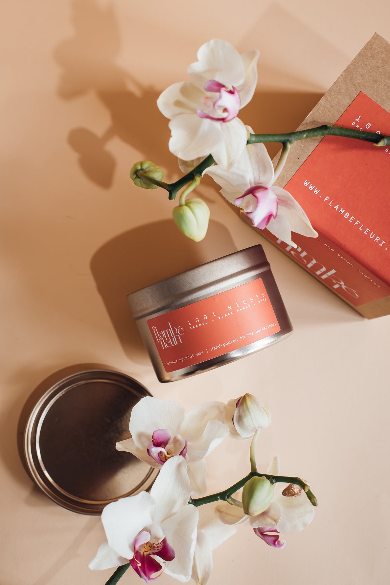 Vegan Scented Candle - Oriental 1001 Nights - Non Toxic . Candle with decorative packaging and white flowers on a beige background