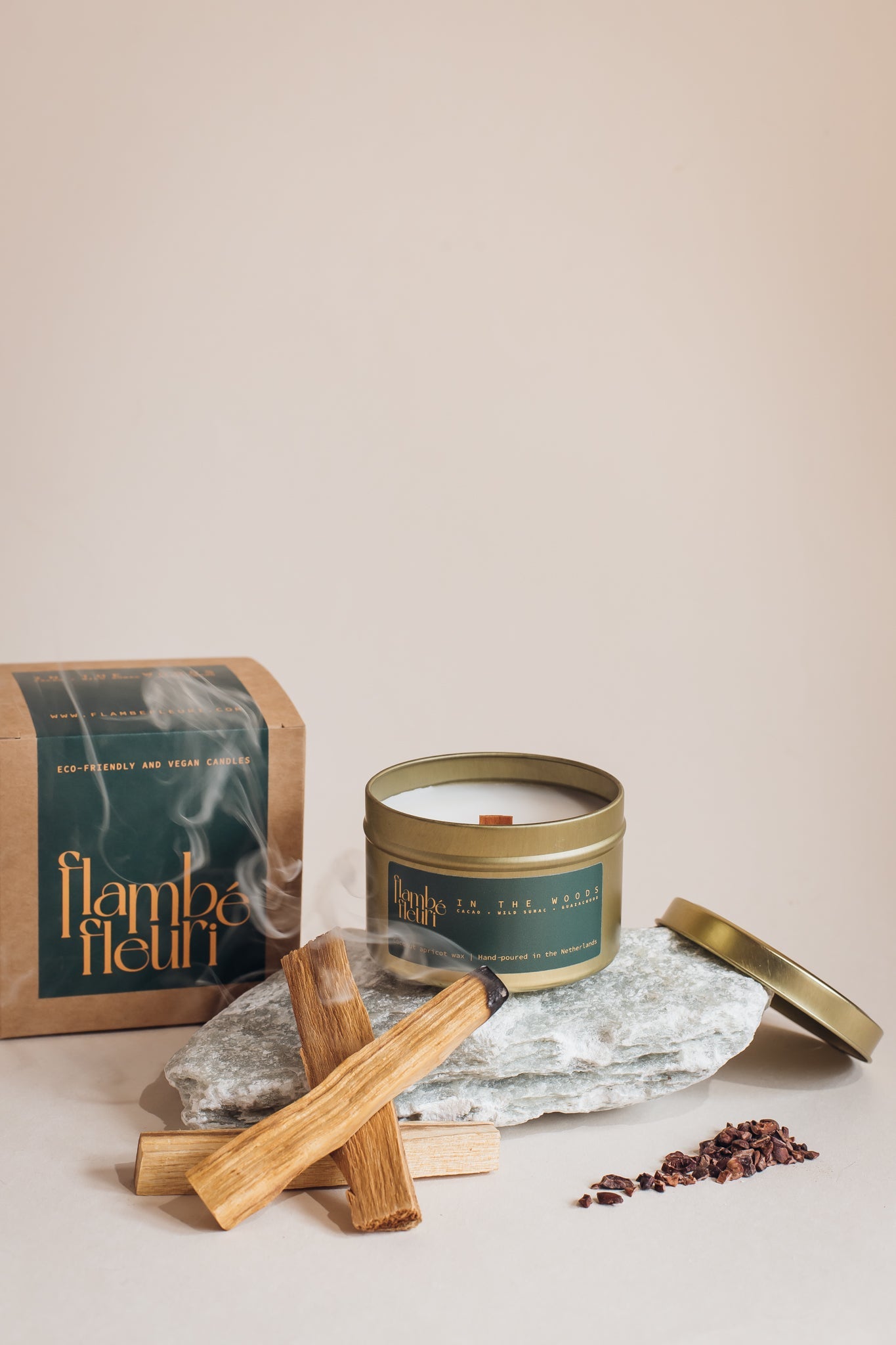 Non toxic vegan Candle in a tin with wooden striker and packaging on a neutral background. Wooden wick 